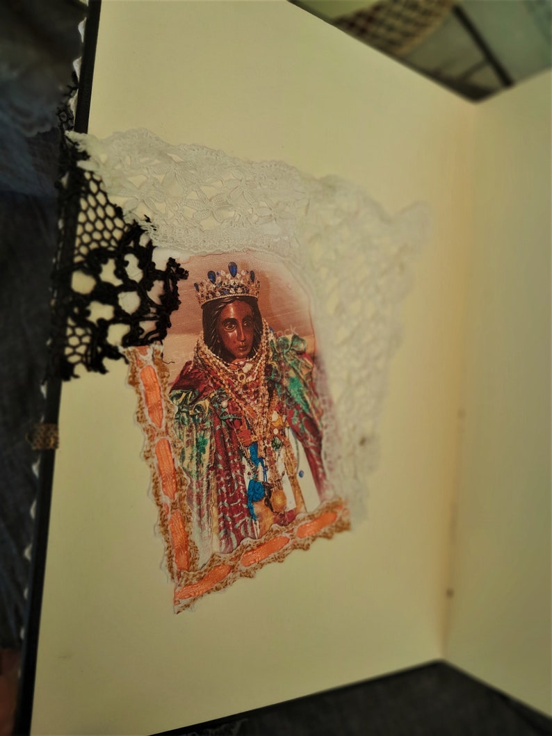 May include: A vintage-style image of a woman wearing a crown and ornate clothing, framed with lace and a decorative border.