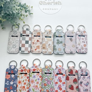 Keep your lip balm close and never lose it again with this cute chapstick holder keychain.  neoprene keychain is perfect to carry your chapstick, lip balm, or lipstick on the go. It is a must-have accessory for anyone who loves convenience and style.