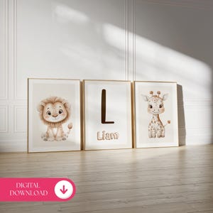 May include: Three framed art prints featuring a lion, a letter "L" with the name "Liam", and a giraffe. The illustrations are in soft, neutral tones, perfect for a nursery or children's room. The frames have a gold finish.