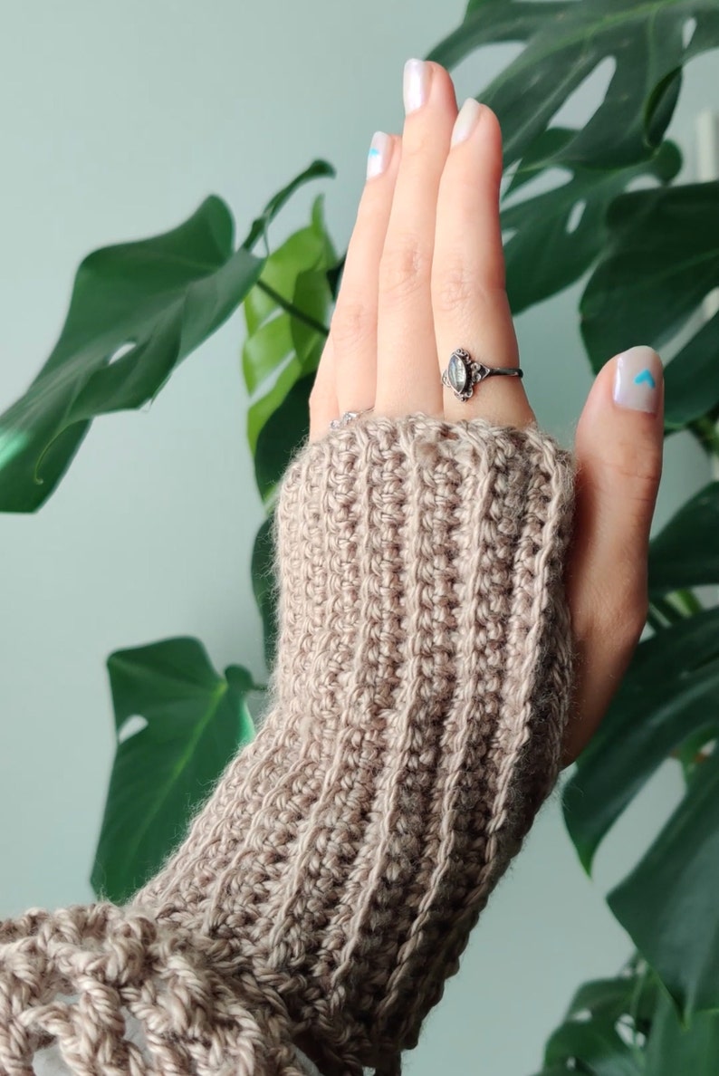 beige glove in front of monstera deliciosa