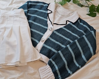 May include: A blue and white striped cardigan with a white collar and white crocheted trim. The cardigan has a button closure and is made of a soft, knitted fabric.