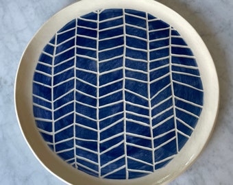 Sgraffito ceramic blue plate with design