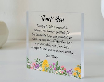 May include: A clear acrylic block featuring the printed text Thank You, followed by a message of gratitude and the signature Love, Sarah. The bottom edge is decorated with a colorful floral illustration of yellow, pink, and purple wildflowers.