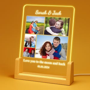 May include: A wooden-based LED light with a rectangular display. The display features multiple photos and the text "Sarah & Jack" at the top. Below the photos is the text "Love you to the moon and back 01.01.2024". The light has a warm yellow glow.