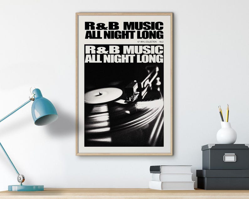 May include: A black and white photo of a record player with the text "R&B MUSIC ALL NIGHT LONG" printed on a white background.