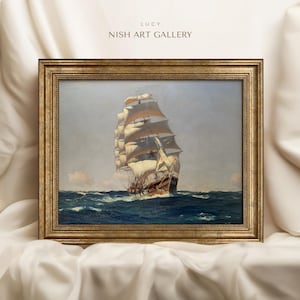 May include: A framed painting of a tall ship with white sails sailing on a blue ocean. The painting is in a gold frame with a decorative border. The title of the painting is "Lucy" and the artist is "Nish Art Gallery".