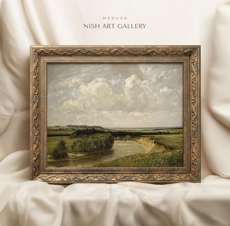 May include: A framed landscape painting depicting a river winding through a green field with a cloudy sky in the background. The frame is ornate and gold in color. The painting is titled "MEDUSA NISH ART GALLERY".