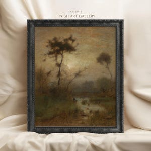 May include: A framed painting depicting a misty landscape with trees and a stream. The painting is in a dark wood frame with a decorative border. The painting is titled "Artemis" and is from the "Nish Art Gallery".