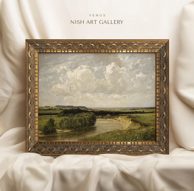 May include: A framed landscape painting depicting a river winding through a green field with a cloudy sky. The frame is ornate and gold in color. The title "VENUS NISH ART GALLERY" is printed at the top of the frame.