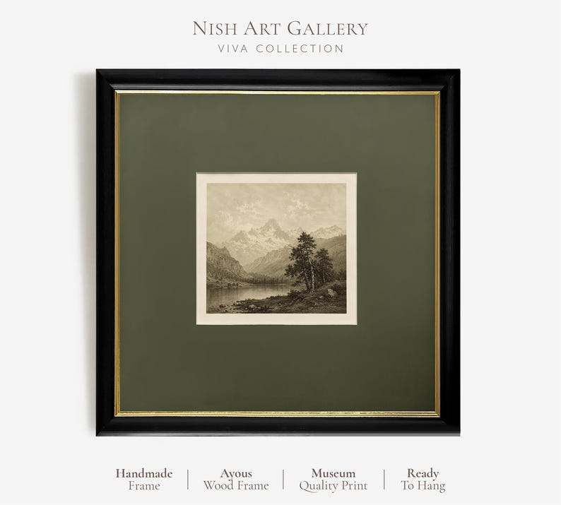 May include: A square framed wall art piece featuring a black wooden frame with a thin gold inner border and a dark olive green mount. The print depicts a sepia-toned mountain landscape with a lake and trees. Text reads NISH ART GALLERY VIVA COLLECTION.