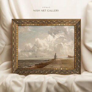 May include: A framed painting of a seascape with a lighthouse in the distance. The painting is in a gold frame with ornate details. The painting is titled "Venus" and is from the "Nish Art Gallery".