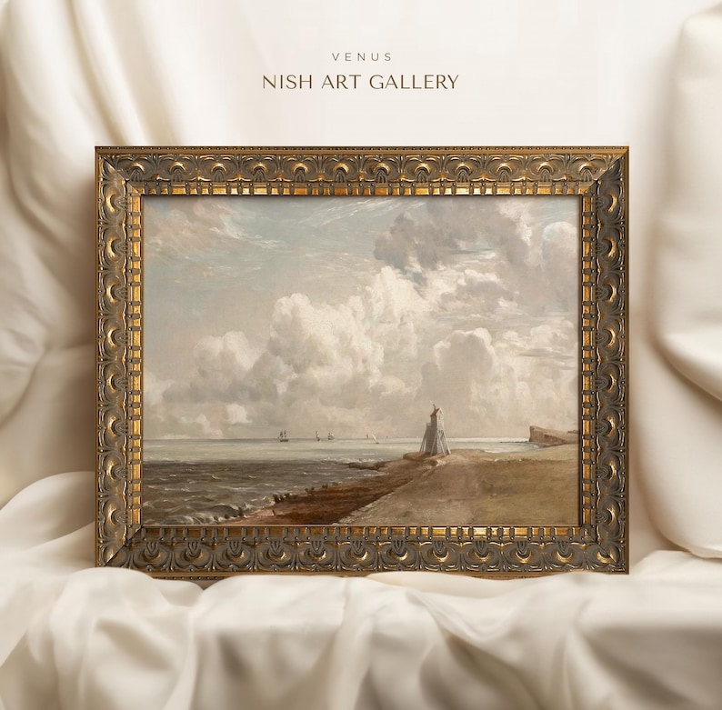 May include: A framed painting of a seascape with a lighthouse in the distance. The painting is in a gold frame with ornate details. The painting is titled "Venus" and is from the "Nish Art Gallery".