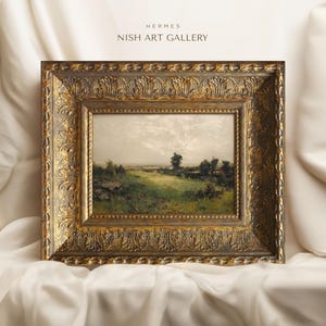 May include: A framed landscape painting depicting a rural scene with a field of green grass, trees, and a cloudy sky. The frame is ornate and gold in colour.