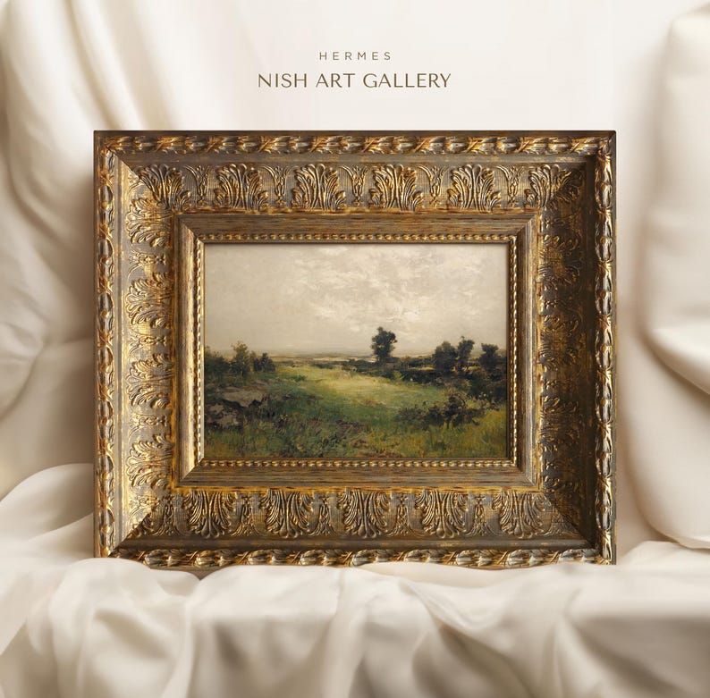 May include: A framed landscape painting depicting a rural scene with a field of green grass, trees, and a cloudy sky. The frame is ornate and gold in colour.