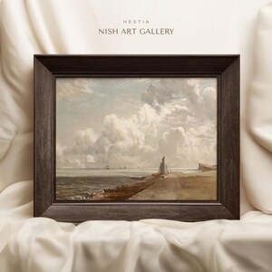 May include: A framed painting depicting a seascape with a lighthouse in the foreground and a cloudy sky. The painting is in a dark brown frame.