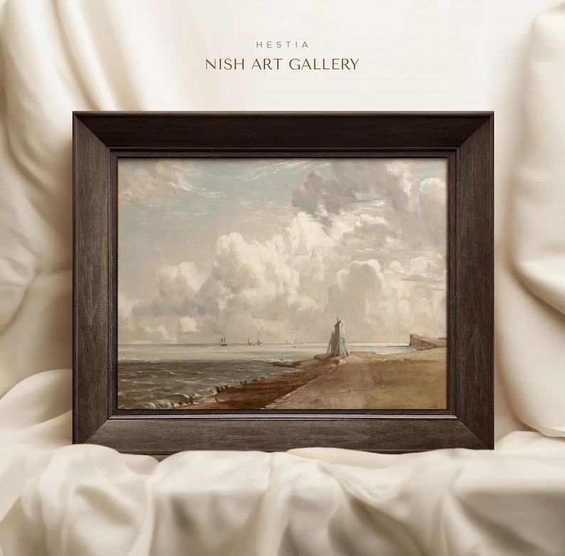 May include: A framed painting depicting a seascape with a lighthouse in the foreground and a cloudy sky. The painting is in a dark brown frame.