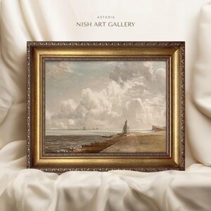 May include: A framed painting depicting a seascape with a lighthouse in the distance. The painting is set against a cloudy sky and features a calm sea with a few boats in the distance. The frame is gold and ornate.