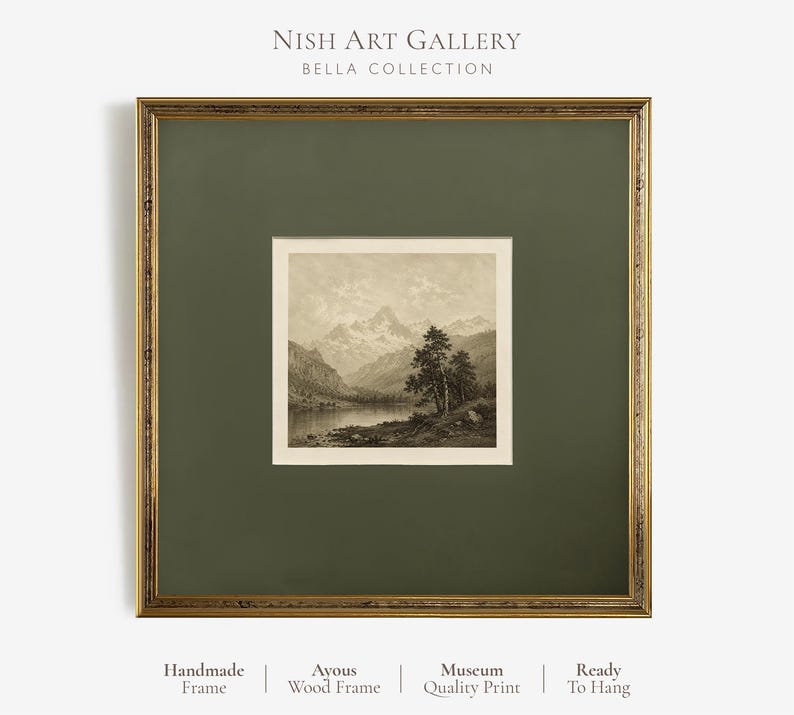 May include: A square framed wall art piece featuring a sepia-toned landscape print of mountains and a lake. The print is set within a dark olive green mount and a decorative gold-toned wooden frame. Text at the top reads Nish Art Gallery Bella Collection.