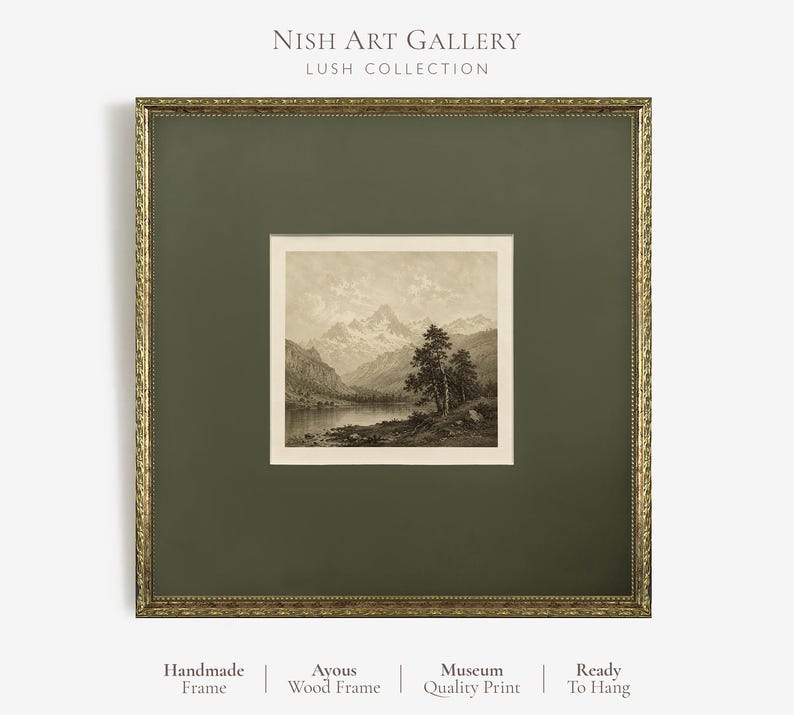 May include: A square framed art print featuring a sepia-toned landscape of mountains, a lake, and trees. The print is set within a dark olive green mat and an ornate gold-coloured frame. Text at the top reads NISH ART GALLERY LUSH COLLECTION.