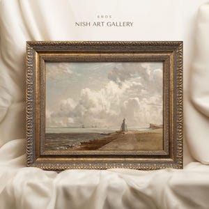 May include: A framed painting depicting a seascape with a cloudy sky, a lighthouse on a rocky shore, and several boats in the distance. The frame is gold with ornate detailing. The painting is titled "EROS NISH ART GALLERY".
