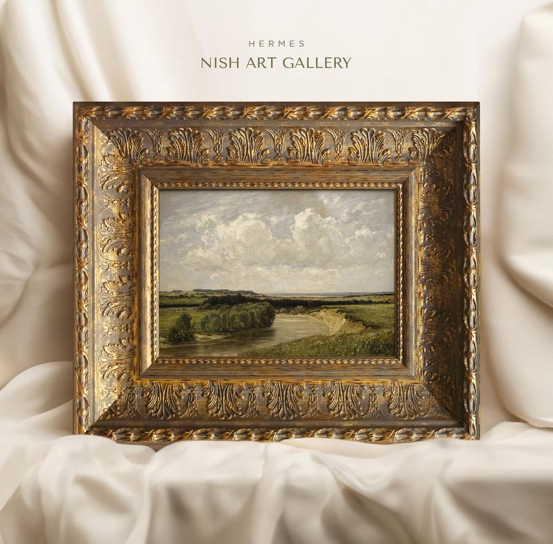 May include: A framed landscape painting depicting a river winding through a green field with a cloudy sky in the background. The frame is ornate and gold in color. The text "HERMES NISH ART GALLERY" is visible at the top of the image.