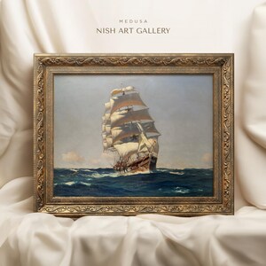 May include: A framed painting of a large sailing ship on the open ocean. The ship has white sails and a brown hull. The painting is in a gold frame with ornate details. The text "MEDUSA NISH ART GALLERY" is at the top of the image.
