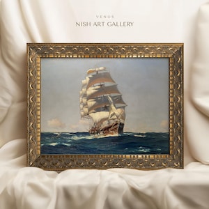 May include: A framed painting of a large sailing ship with white sails against a blue sky and ocean. The frame is ornate and gold in color. The title "VENUS NISH ART GALLERY" is printed at the top of the frame.