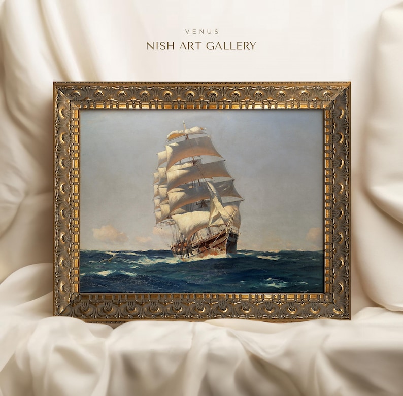 May include: A framed painting of a large sailing ship with white sails against a blue sky and ocean. The frame is ornate and gold in color. The title "VENUS NISH ART GALLERY" is printed at the top of the frame.