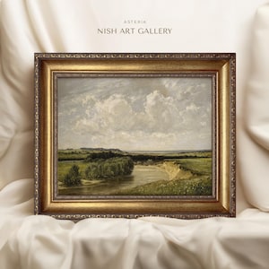 May include: A framed landscape painting depicting a river winding through a green field with a cloudy sky in the background. The frame is gold with ornate detailing. The painting is titled "Asteria Nish Art Gallery".