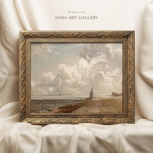 May include: A framed painting depicting a seascape with a cloudy sky and a distant shoreline. The painting is in a gold frame with ornate details. The title "MEDUSA NISH ART GALLERY" is visible at the top of the image.
