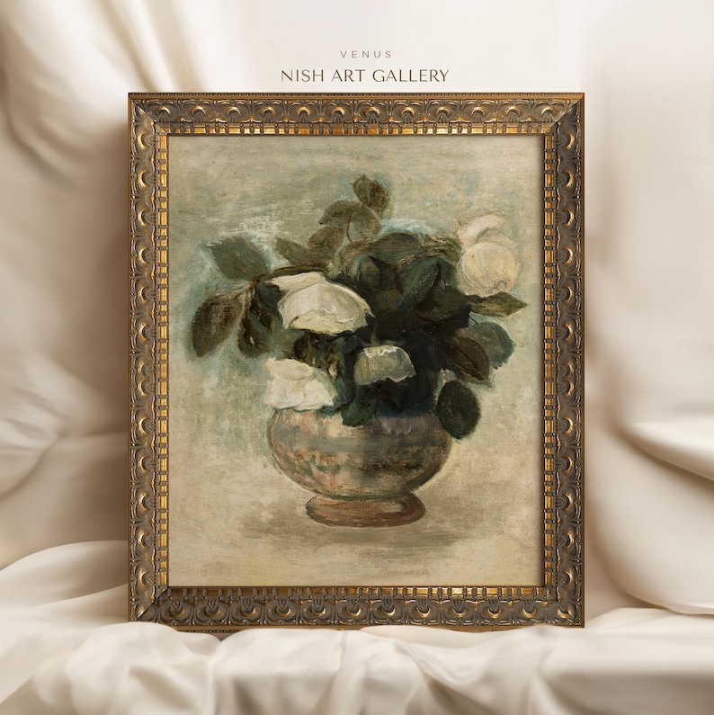May include: A framed painting of a bouquet of white roses in a vase. The painting is in a gold frame with ornate details. The background is a light beige color. The title of the painting is "Venus" and the artist is "Nish Art Gallery".