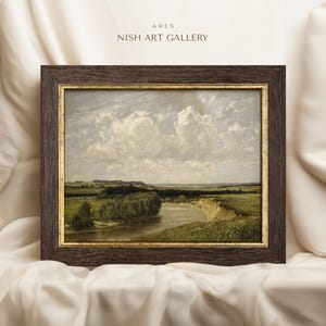 May include: A framed painting depicting a landscape with a river winding through a field. The sky is a light blue with fluffy white clouds. The painting is in a dark brown frame with a gold trim.