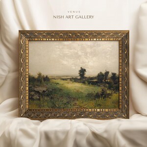 May include: A framed landscape painting depicting a rural scene with a grassy field, trees, and a cloudy sky. The frame is ornate and gold in colour. The painting is titled "Venus" and the artist is "Nish Art Gallery".