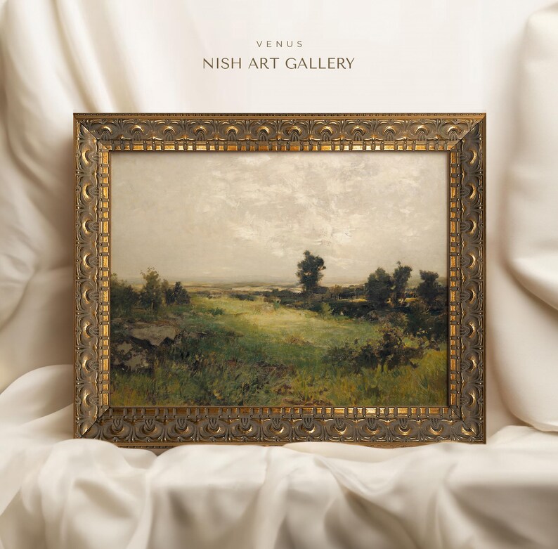 May include: A framed landscape painting depicting a rural scene with a grassy field, trees, and a cloudy sky. The frame is ornate and gold in colour. The painting is titled "Venus" and the artist is "Nish Art Gallery".