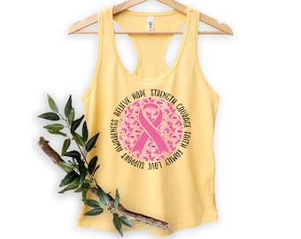 May include: Yellow tank top with a pink ribbon and the words "Believe, Hope, Strength, Courage, Faith, Family, Love, Support, Awareness" around it.