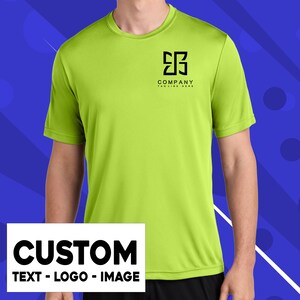 a man wearing a neon green t - shirt and black shorts