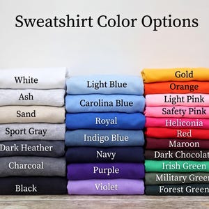 A collection of various colored t-shirts, each with a different color option, arranged in a grid-like pattern.