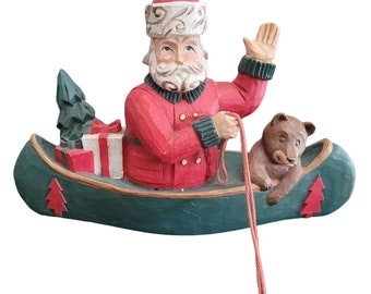 Importadores del Medio Oeste Santa pescando en canoa con oso