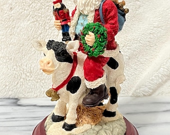 VTG Jaimy Santa Claus montando una vaca blanca y negra sosteniendo un cascanueces Kmart