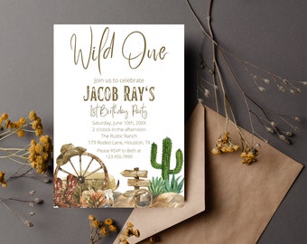 May include: A Wild One themed first birthday party invitation with a watercolor illustration of a wagon wheel, cowboy boots, cacti, and a sign. The invitation is for Jacob Ray's 1st birthday party on Saturday, June 10th, 20XX at 2 o'clock in the afternoon at The Rustic Ranch, 179 Rodeo Lane, Houston, TX. Please RSVP to Beth at 123.456.7890.