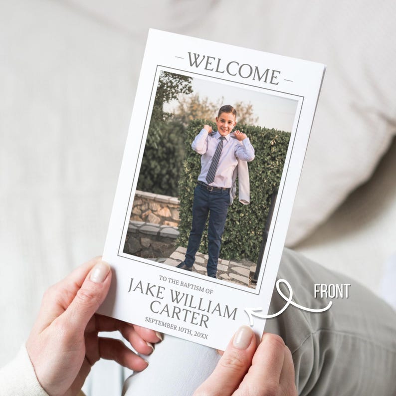 May include: A white welcome card with a photograph of a boy in a suit. The card reads "WELCOME" at the top and "TO THE BAPTISM OF JAKE WILLIAM CARTER SEPTEMBER 10TH, 20XX" at the bottom. The word "FRONT" is indicated with an arrow.