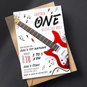 May include: A white and black birthday party invitation with a red electric guitar graphic. The text reads "Another One Bites the Dust" and "Rock on over for Axel's 1st Birthday". The date is August 10th, 3 to 5 PM. The location is Axel's Stage, 309 Fender Avenue, Cleveland, Ohio. RSVP to Katie at 123.456.7890.