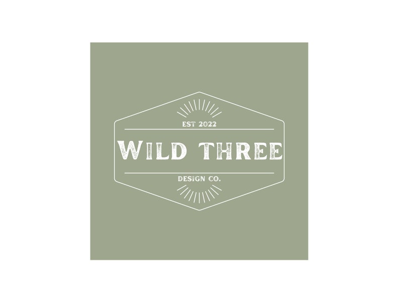 May include: A white logo on a sage green background. The logo is a hexagon with a starburst design at the top and bottom. The text inside the hexagon reads "WILD THREE DESIGN CO. EST 2022".
