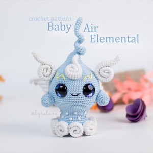 May include: A light blue crocheted Baby Air Elemental figure with white detailing and large, glossy black eyes. The figure has a smiling face and decorative swirls. Text on the image reads "crochet pattern" and "Baby Air Elemental".