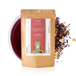 May include: A brown paper pouch with a white label that says "Strawberry Hibiscus" and "8 Ounce Bulk Pouch Fruity Tea". The label also has a cartoon rabbit sitting in a chair and reading a book. The pouch is open and there is a pile of loose leaf tea on a white background.