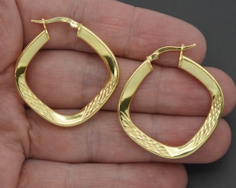 May include: A pair of gold square hoop earrings with a textured design. The earrings have a hinged closure.