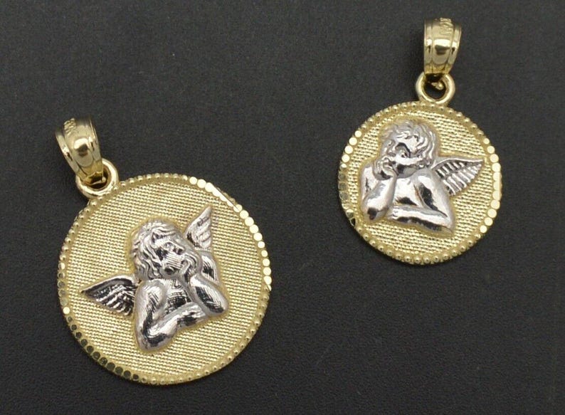 May include: Two gold angel pendant necklaces. The pendants are round and feature a detailed image of an angel with wings. The angel is made of silver and is set against a gold background.