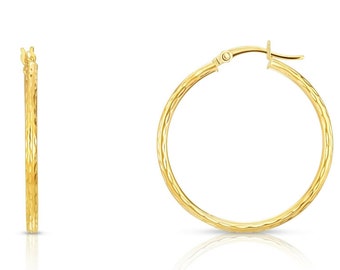 May include: A pair of gold hoop earrings with a textured finish. The earrings have a hinged closure.