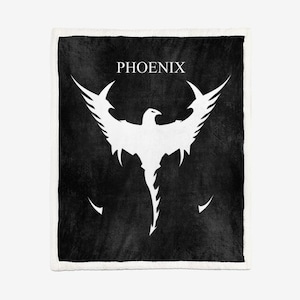 May include: A black and white blanket with a white phoenix design and the word "PHOENIX" at the top. The phoenix has outstretched wings. The blanket has a white border.
