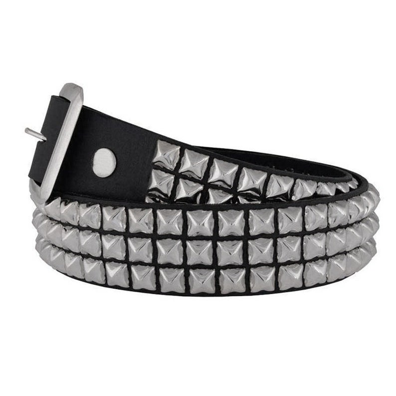 May include: A black leather belt with silver pyramid-shaped studs. The belt has a silver buckle and is layered with three rows of studs.